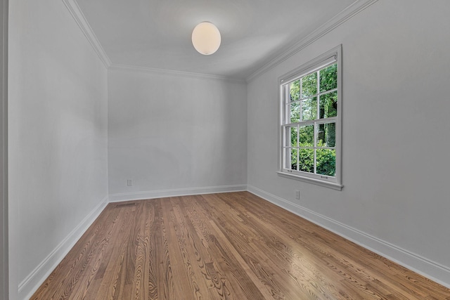 unfurnished room featuring crown molding and hardwood / wood-style flooring