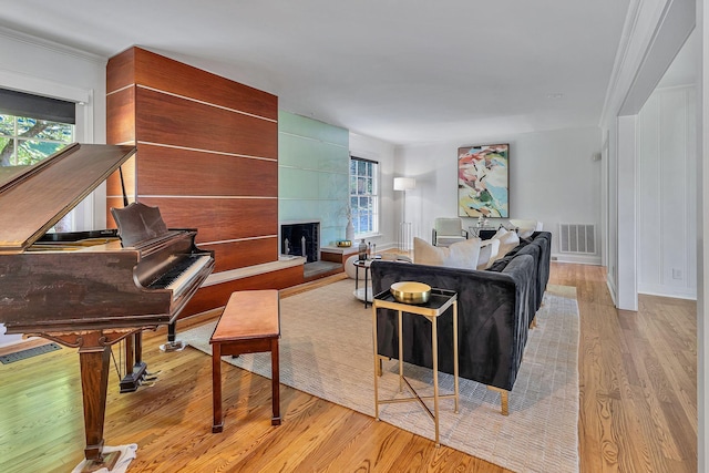 living room with a fireplace and light wood-type flooring