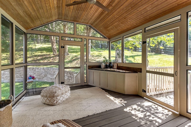 unfurnished sunroom with lofted ceiling, wooden ceiling, and ceiling fan