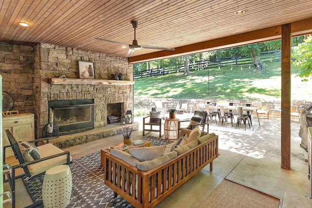 view of patio / terrace featuring an outdoor living space with a fireplace and ceiling fan