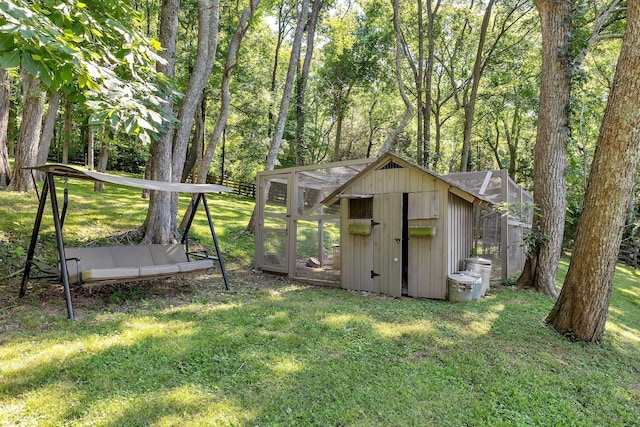 view of outbuilding featuring a lawn