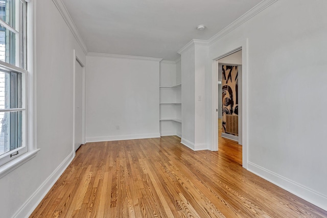 unfurnished room with crown molding and light wood-type flooring