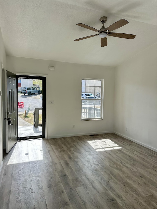 entrance foyer featuring baseboards and wood finished floors