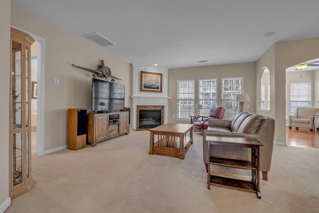 living room featuring a premium fireplace and light carpet