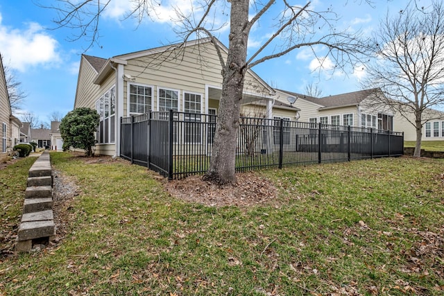 back of property with a garage and a lawn