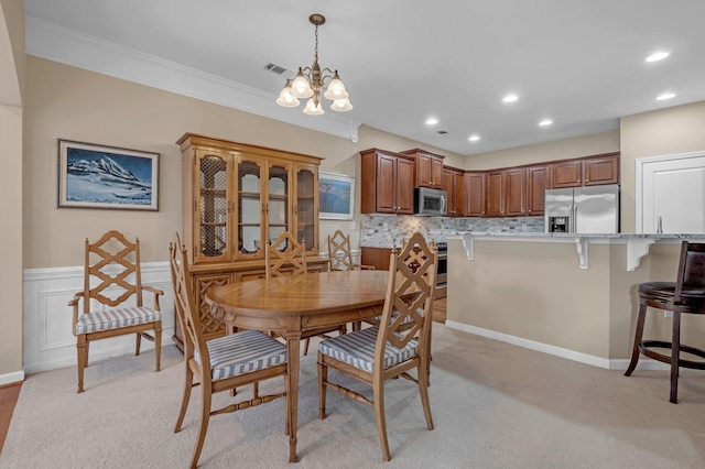 carpeted dining space featuring crown molding and a notable chandelier