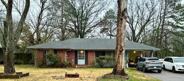 single story home with a front lawn and a carport