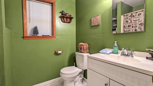 bathroom featuring vanity, tile patterned floors, and toilet