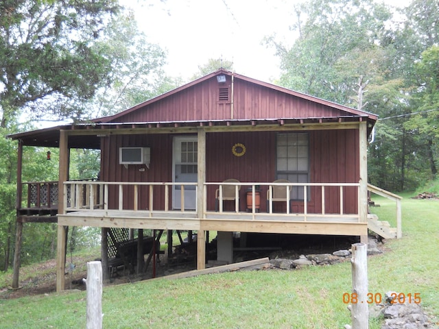 back of house with a lawn