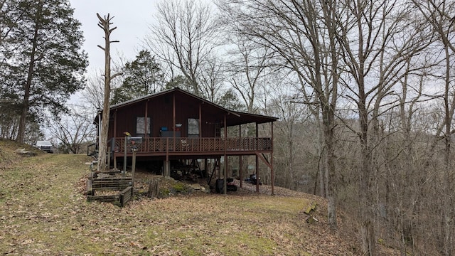 rear view of property with a wooden deck