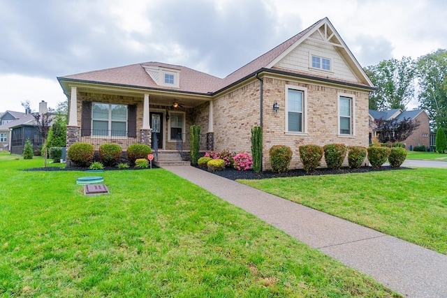 craftsman-style home with a porch and a front lawn