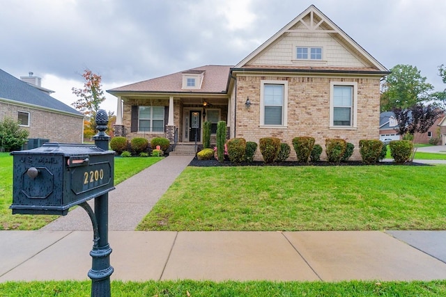 view of front of property with covered porch and a front lawn