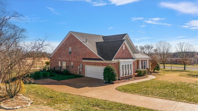 view of side of home with a garage and a yard