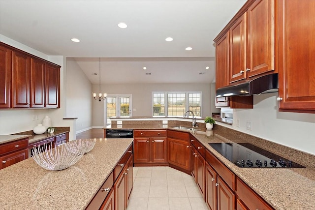 kitchen with light tile patterned flooring, sink, light stone counters, hanging light fixtures, and black appliances