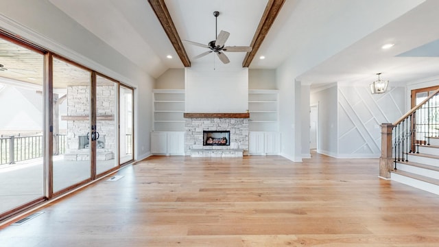 unfurnished living room with a stone fireplace, ceiling fan with notable chandelier, vaulted ceiling with beams, light hardwood / wood-style floors, and built in shelves