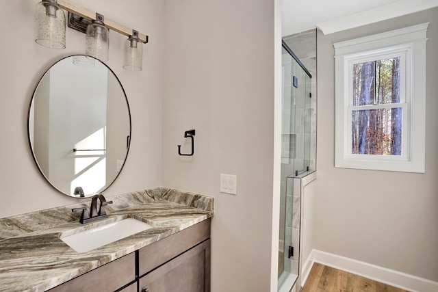 bathroom featuring vanity, wood-type flooring, and walk in shower