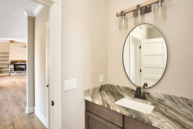 bathroom featuring vanity, hardwood / wood-style floors, and ceiling fan