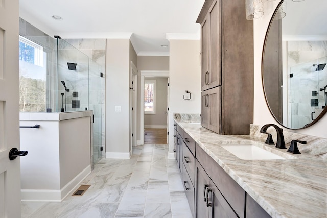 bathroom featuring vanity, crown molding, and walk in shower