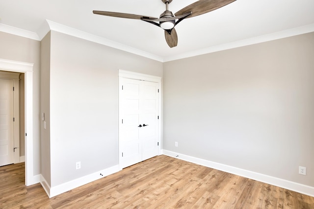 unfurnished bedroom featuring ornamental molding, a closet, and light hardwood / wood-style flooring