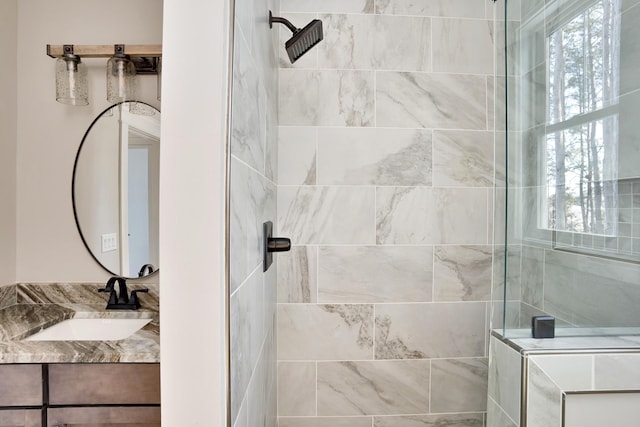 bathroom with vanity and tiled shower