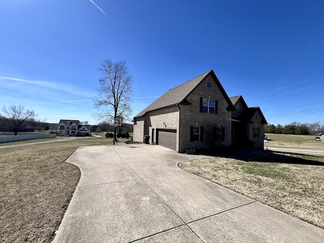 view of property exterior with concrete driveway, brick siding, a yard, and an attached garage