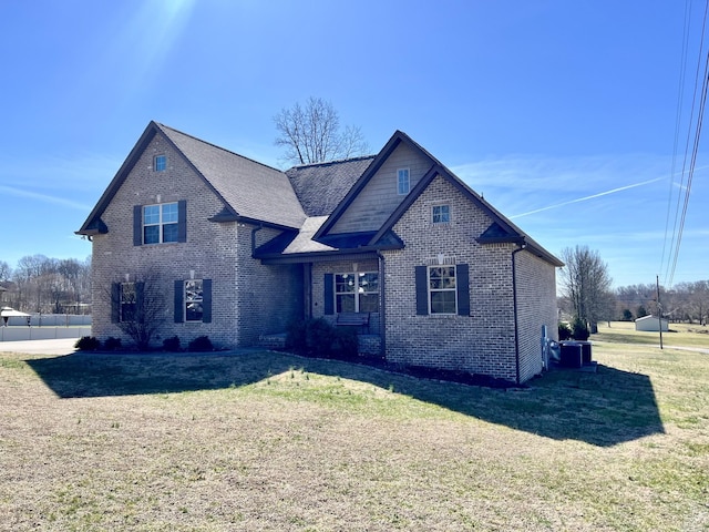 view of front of house with a front lawn and brick siding