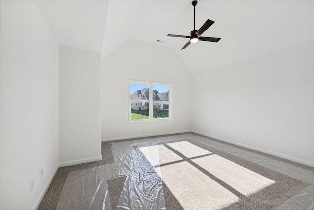 carpeted spare room featuring lofted ceiling and ceiling fan