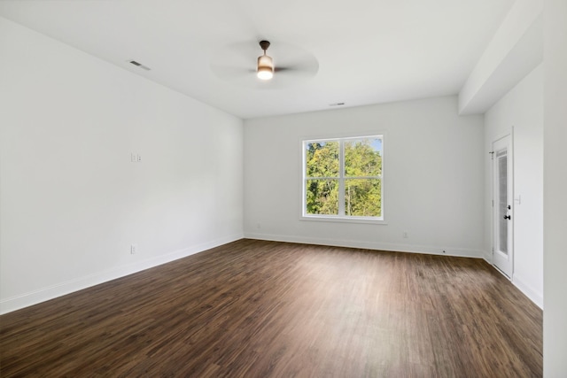 spare room featuring dark wood-type flooring and ceiling fan