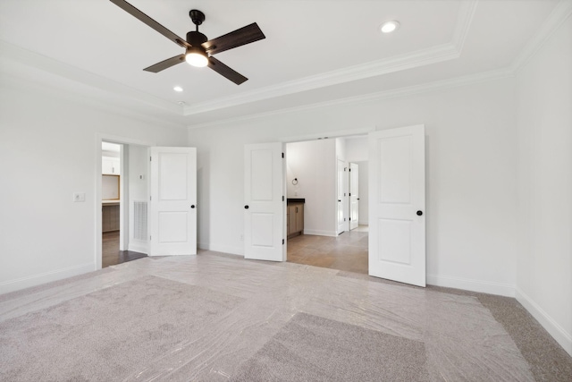 unfurnished room with crown molding, light carpet, ceiling fan, and a tray ceiling