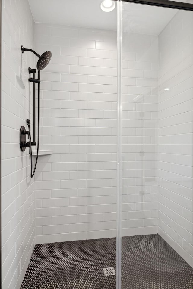 bathroom featuring a shower with door