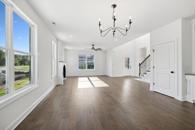 unfurnished living room featuring dark hardwood / wood-style flooring and ceiling fan with notable chandelier