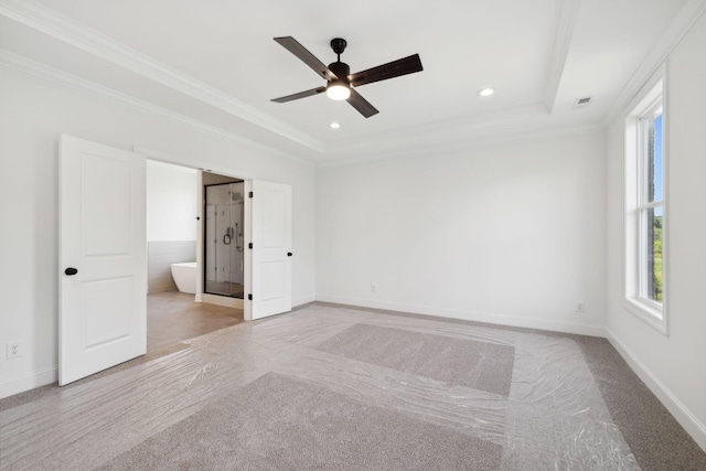 empty room featuring crown molding, ceiling fan, and a tray ceiling