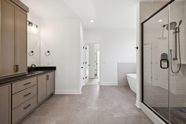 bathroom featuring vanity and shower with separate bathtub