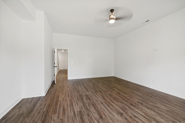 empty room featuring dark wood-type flooring and ceiling fan