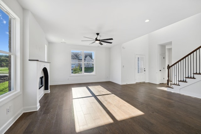 unfurnished living room featuring dark hardwood / wood-style floors and ceiling fan