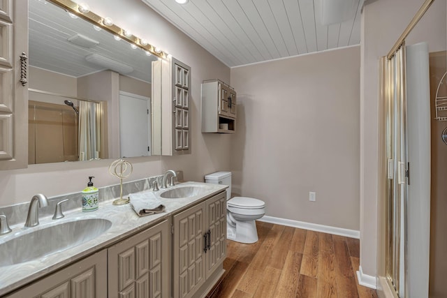 bathroom with hardwood / wood-style floors, a shower with shower door, vanity, toilet, and wooden ceiling