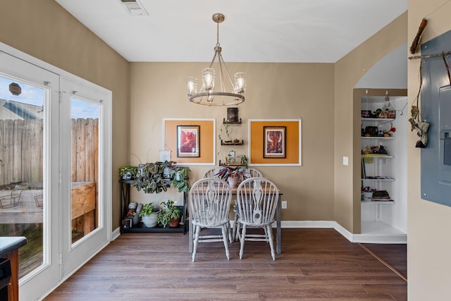 dining space featuring an inviting chandelier and wood-type flooring