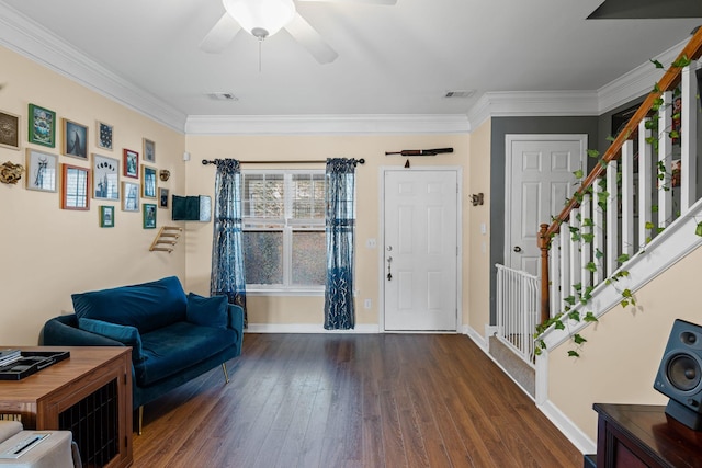 foyer entrance featuring crown molding, ceiling fan, and dark hardwood / wood-style floors