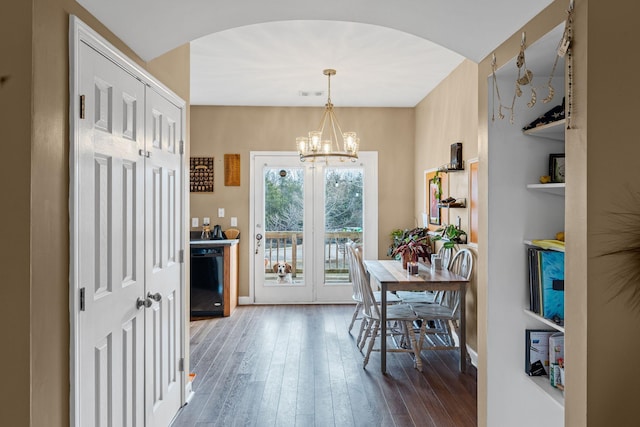 dining space featuring an inviting chandelier and hardwood / wood-style floors