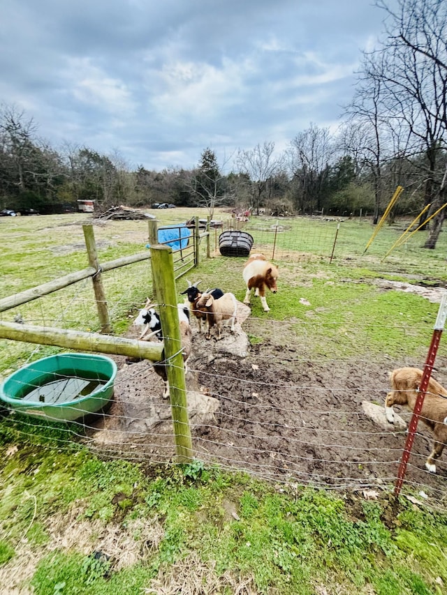 exterior space with a rural view and fence