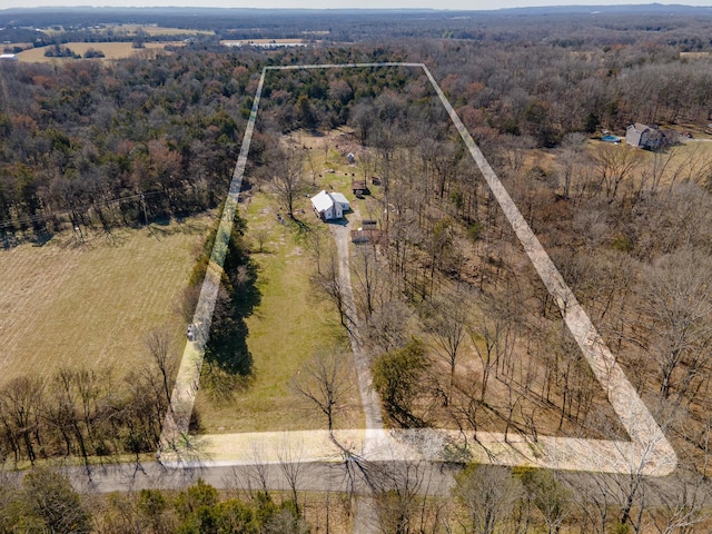 birds eye view of property with a wooded view