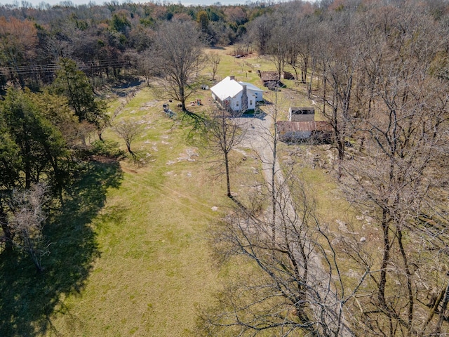 birds eye view of property with a wooded view