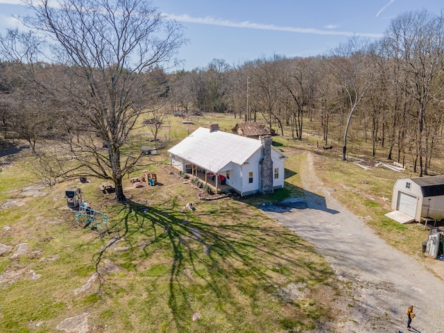 drone / aerial view featuring a wooded view