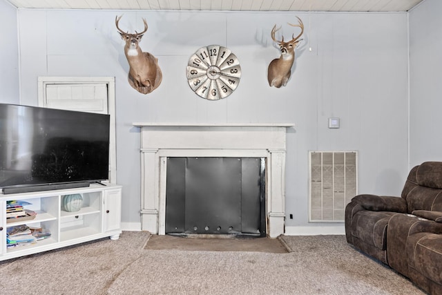 living room with wood ceiling, a fireplace with flush hearth, visible vents, and carpet flooring