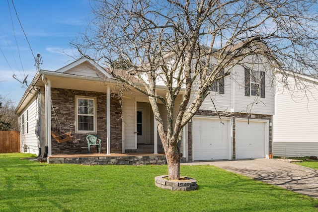 view of front facade featuring a porch, a front yard, a garage, stone siding, and driveway