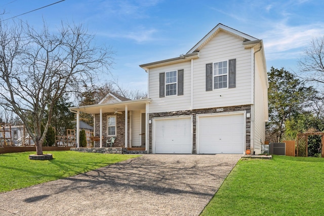 view of front facade with driveway, an attached garage, fence, and a front yard