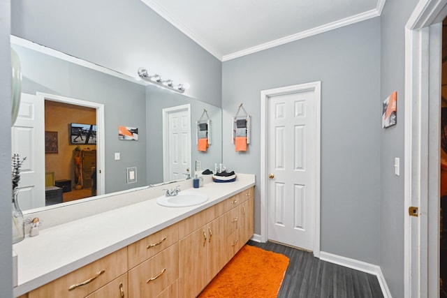 bathroom featuring wood-type flooring, crown molding, and vanity