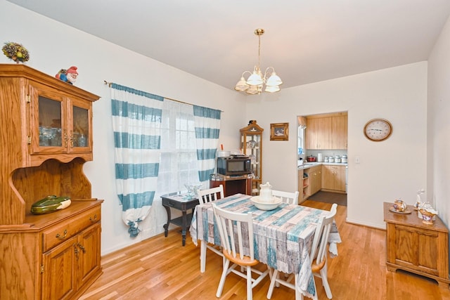 dining room featuring light hardwood / wood-style floors and an inviting chandelier