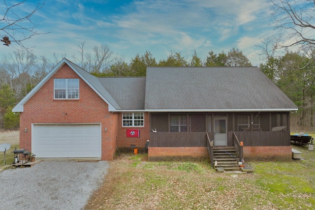 view of front facade with a garage, a sunroom, and a front yard