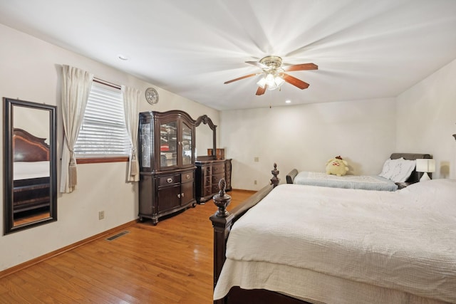 bedroom with ceiling fan and light hardwood / wood-style floors